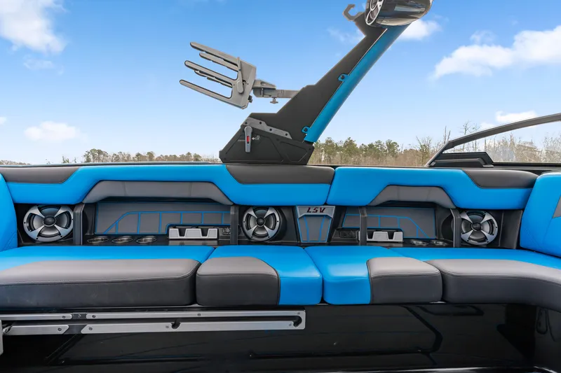 Slide: The Image of 2021 Malibu Wakesetter 25 LSV interior with blue seating and speaker system. - 8