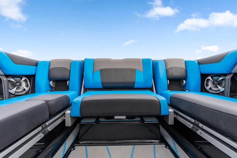 Slide: The Image of 2021 Malibu Wakesetter 25 LSV interior with blue and black seating under a clear sky. - 9