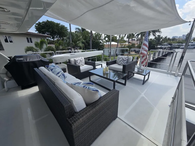 Slide: The Image of Luxurious outdoor seating on 2007 MCP Tri-Deck yacht, featuring elegant wicker furniture and scenic marina views. - 17
