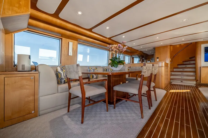 Slide: The Image of Luxurious interior of 2007 MCP Tri-Deck yacht with elegant dining area and wooden flooring. - 26