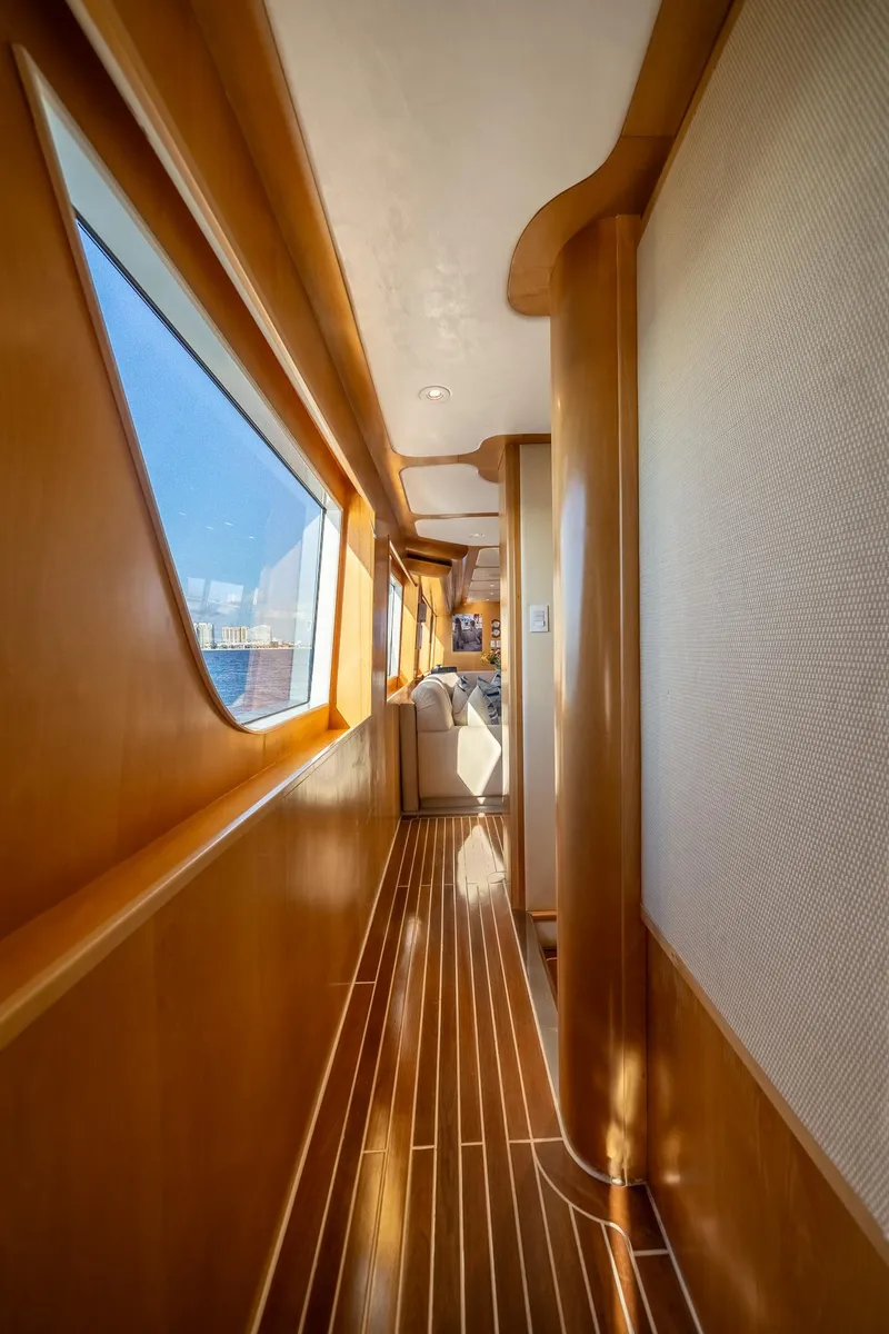Slide: The Image of Luxurious wooden interior hallway of a 2007 MCP Tri-Deck yacht with large windows. - 37