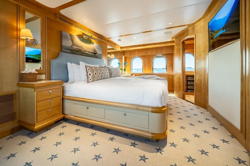 Slide: The Image of Luxurious bedroom on 2007 MCP Tri-Deck yacht with elegant wood finishes and star-patterned carpet. - 38