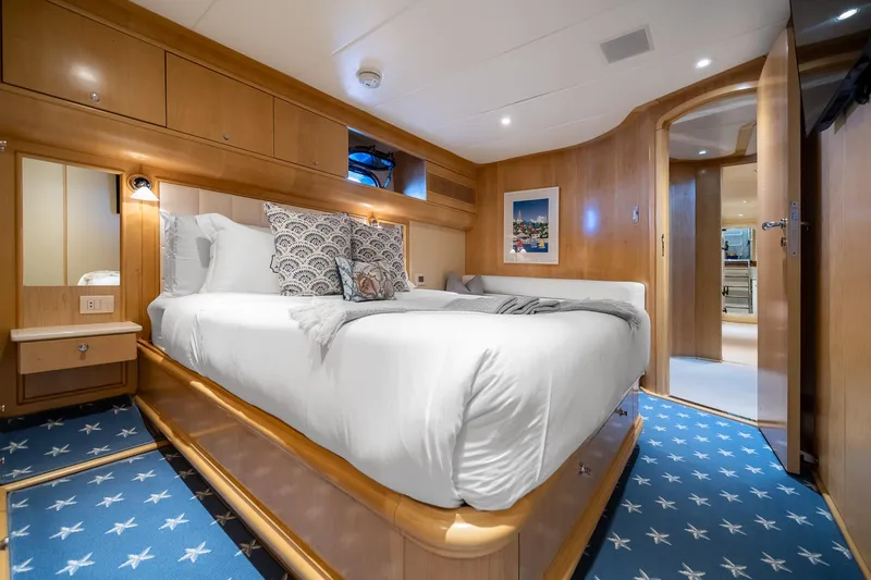 Slide: The Image of Luxurious bedroom interior on 2007 MCP Tri-Deck yacht with elegant wood finishes. - 44