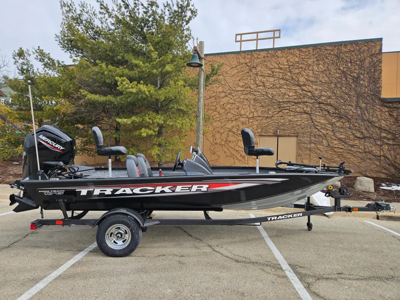 The Image of 2025 Tracker Pro Team 175 boat on trailer in parking lot. - 0