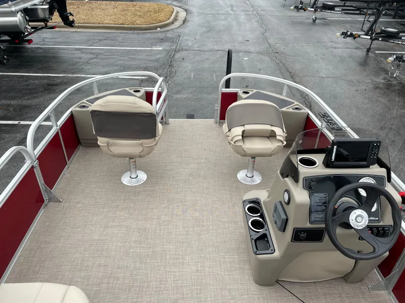 Slide: The Image of 2025 Sun Tracker Bass Buggy 18 DLX pontoon boat interior with seating and steering console. - 4