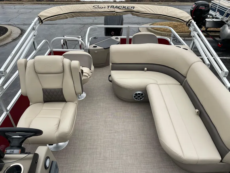 Slide: The Image of 2025 Sun Tracker Bass Buggy 18 DLX pontoon boat with beige seating and canopy. - 5