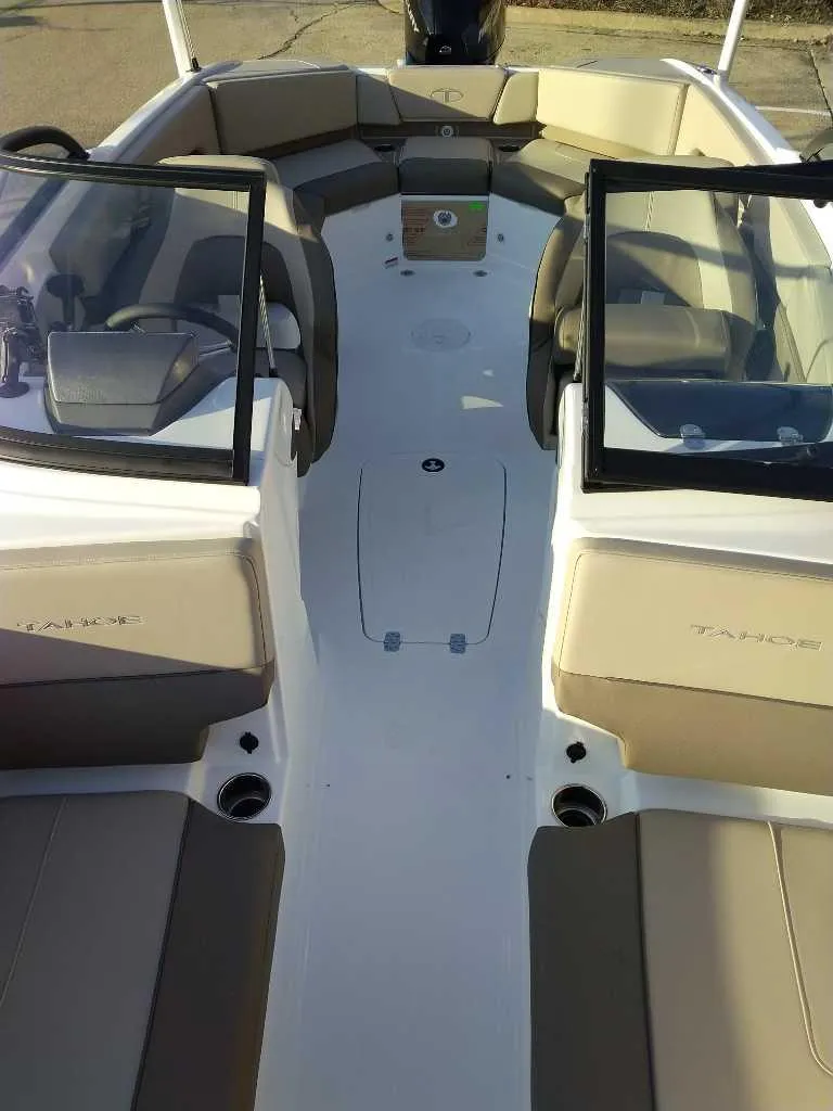 Slide: The Image of 2025 Tahoe 210 S boat interior with beige seating and dual windshields. - 3