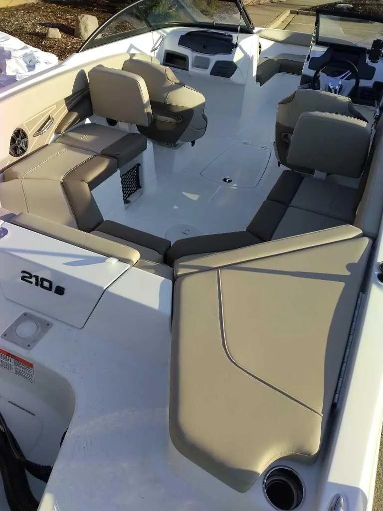 Slide: The Image of 2025 Tahoe 210 S boat interior with beige seating and modern dashboard. - 5