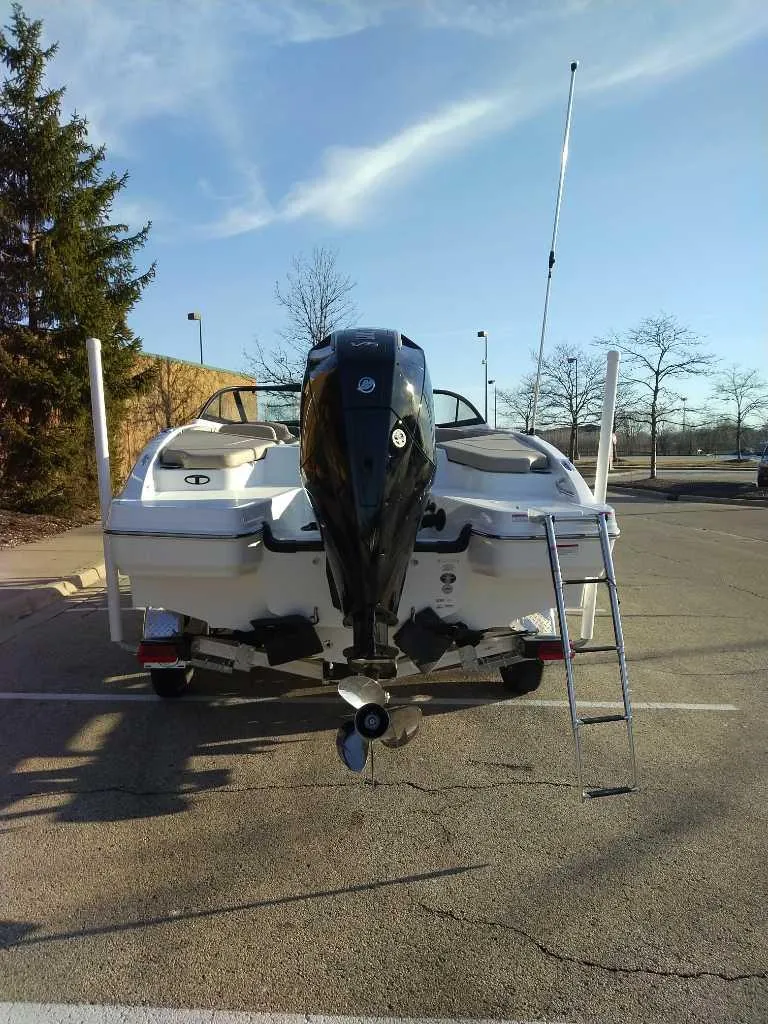 Slide: The Image of 2025 Tahoe 210 S boat with outboard motor in a parking lot. - 6