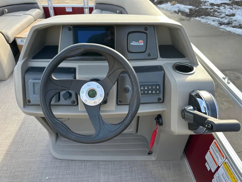 Slide: The Image of 2025 Sun Tracker Party Barge 18 DLX steering console with controls and dashboard. - 6