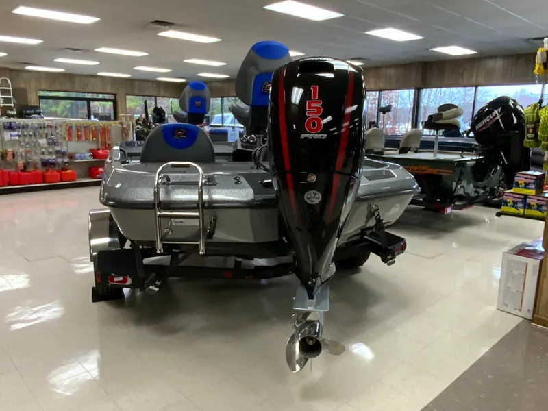 Slide: The Image of 2025 Ranger Z185 boat with 150 HP engine displayed in a showroom. - 3