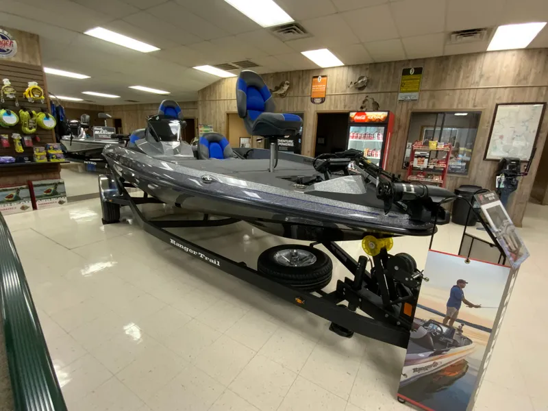 Slide: The Image of 2025 Ranger Z185 boat displayed indoors with blue seats and trailer. - 6