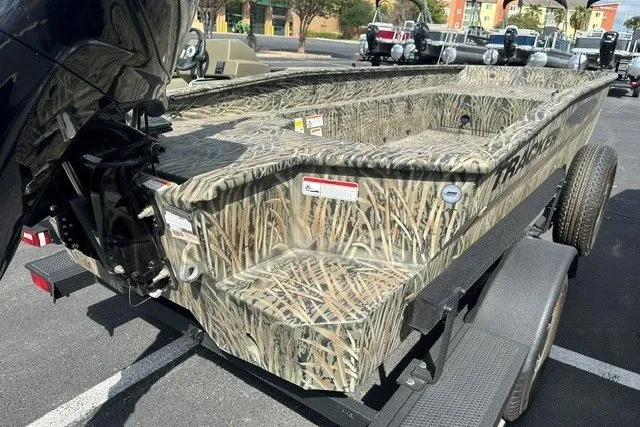 Slide: The Image of 2025 Tracker Grizzly 1650 T Prairie Wings Edition boat with camouflage design on a trailer. - 11