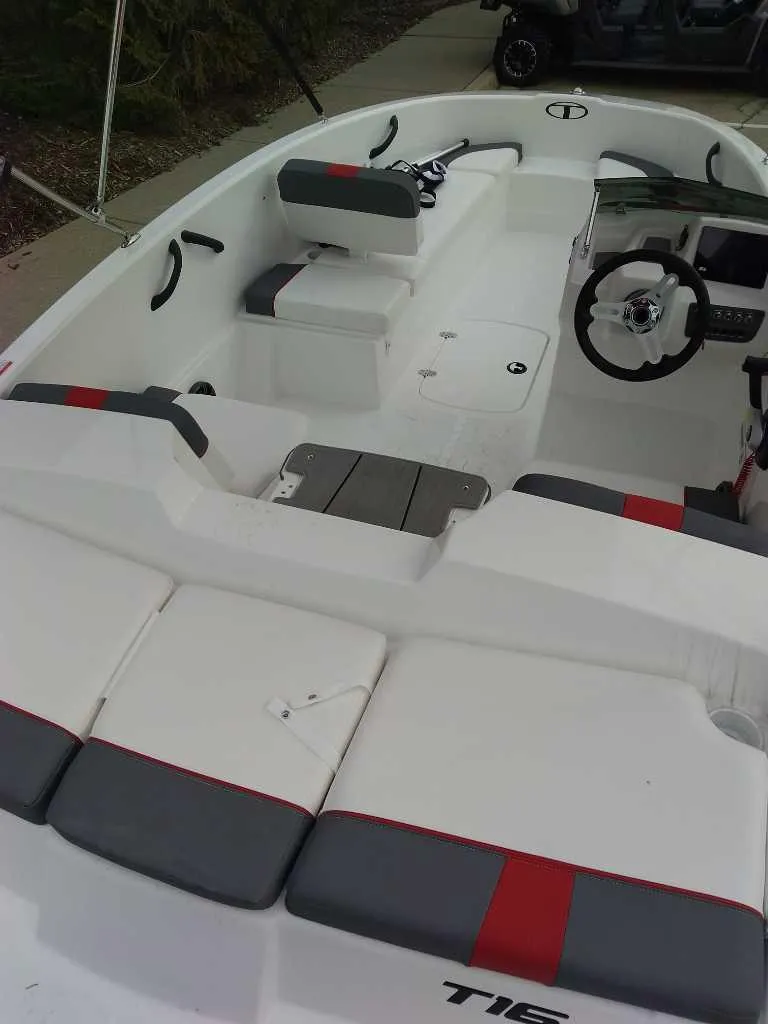 Slide: The Image of 2025 Tahoe T16 boat interior with white and gray seating, modern dashboard, and steering wheel. - 3