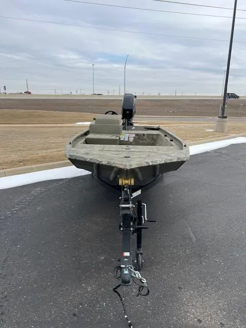 Slide: The Image of 2025 Tracker Grizzly 1648 SC boat on trailer, parked on asphalt. - 4