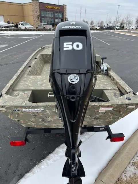 Slide: The Image of 2025 Tracker Grizzly 1648 SC boat with Mercury 50 outboard motor in parking lot. - 7