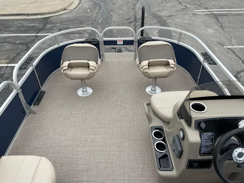Slide: The Image of 2025 Sun Tracker Bass Buggy 16 XL Select pontoon boat interior with seating and console. - 5