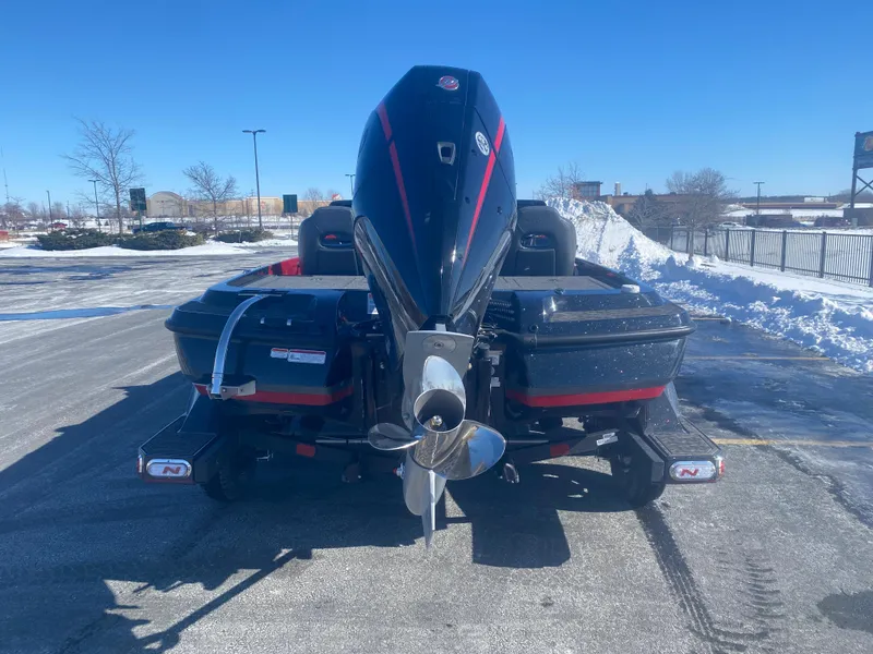 Slide: The Image of 2025 Nitro Z21 XL Pro boat with powerful outboard motor in snowy parking lot. - 3