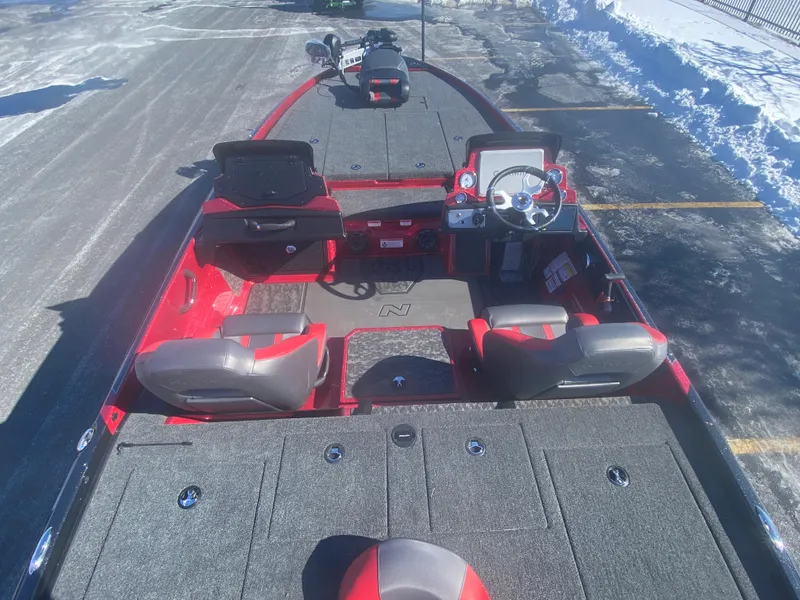 Slide: The Image of 2025 Nitro Z21 XL Pro fishing boat with red and gray interior, parked on snowy pavement. - 4
