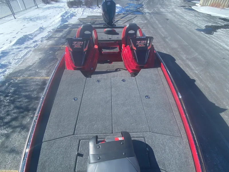 Slide: The Image of 2025 Nitro Z21 XL Pro boat with spacious deck and dual seats, parked on snowy pavement. - 8