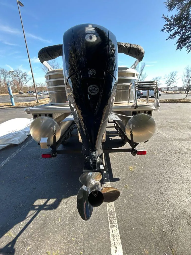 Slide: The Image of 2025 Sun Tracker Party Barge 22 DLX pontoon boat, rear view with outboard motor. - 3