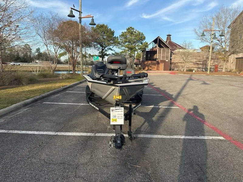Slide: The Image of 2025 Tracker Pro Team 175 Crappie Edition boat parked in a lot, front view. - 3