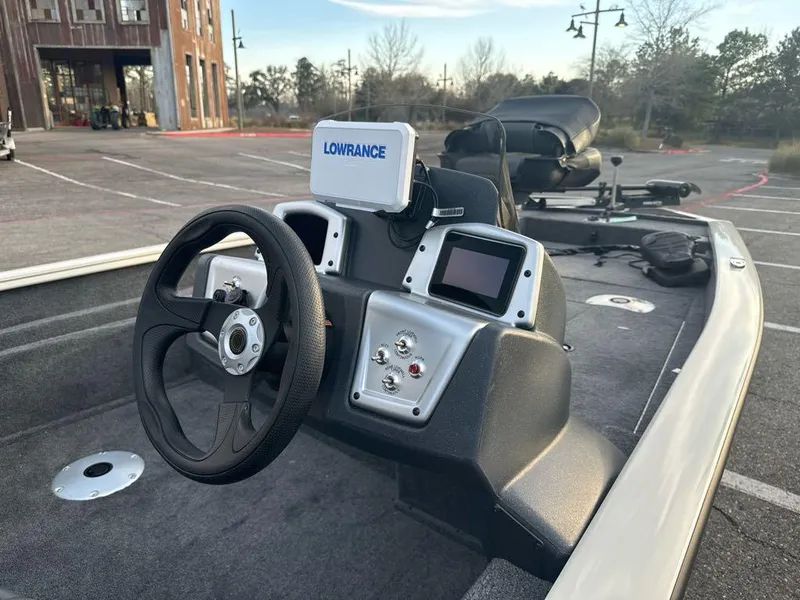 Slide: The Image of 2025 Tracker Pro Team 175 Crappie Edition boat interior with steering wheel and Lowrance electronics. - 7
