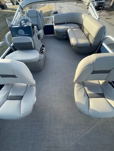 Slide: The Image of 2025 Sun Tracker Bass Buggy 16 XL Select pontoon boat interior with beige seating. - 2