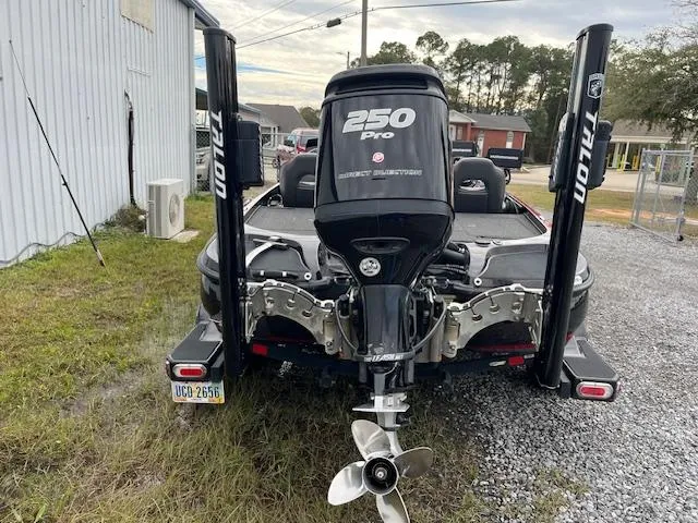 Slide: The Image of 2018 Nitro Z21 DC boat with 250 Pro engine, parked on gravel. - 3
