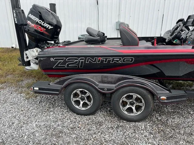 Slide: The Image of 2018 Nitro Z21 DC boat with Mercury engine, parked on gravel. - 4