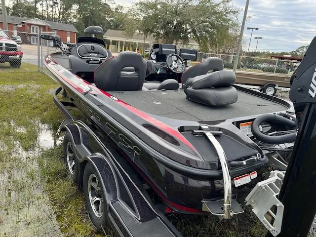 Slide: The Image of 2018 Nitro Z21 DC boat with dual console, parked on a trailer in an outdoor setting. - 7