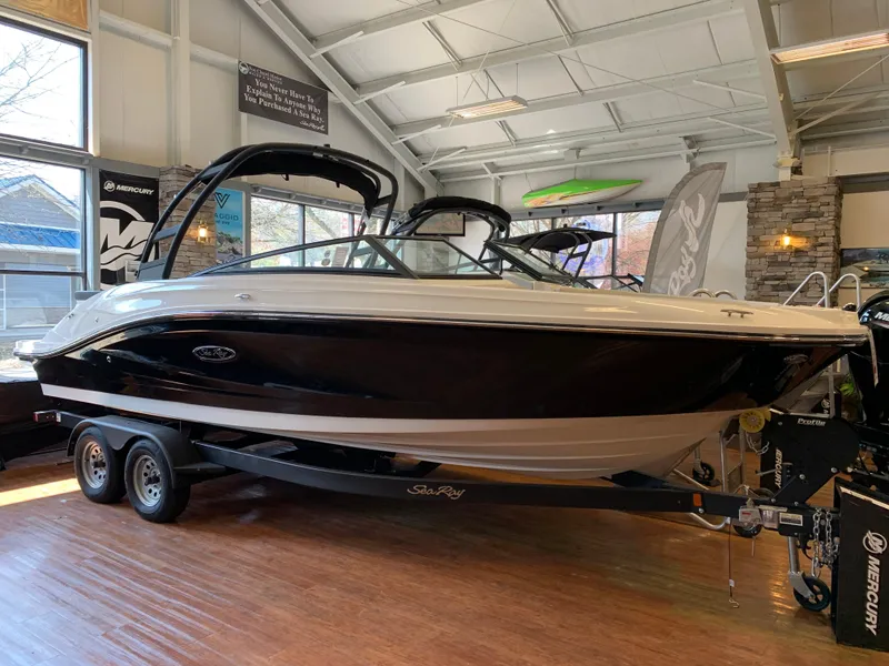 The Image of 2025 Sea Ray SPX 230 boat displayed indoors on a trailer. - 0