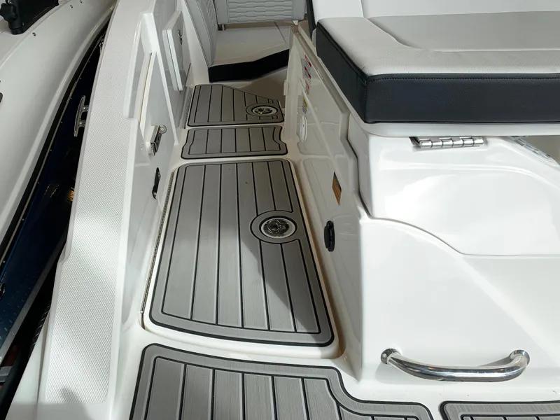 Slide: The Image of 2025 Sea Ray SPX 230 boat interior with sleek seating and modern flooring design. - 2
