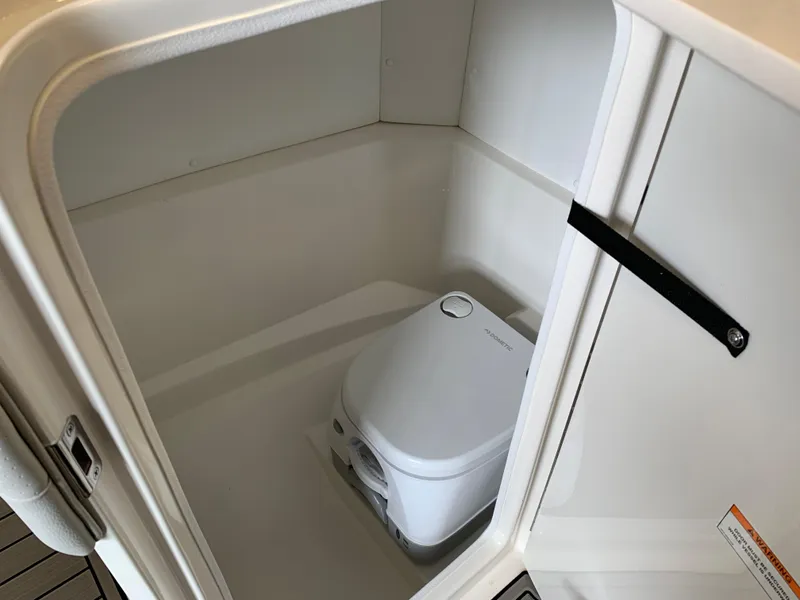 Slide: The Image of Portable toilet inside 2025 Sea Ray SPX 230 boat compartment. - 5