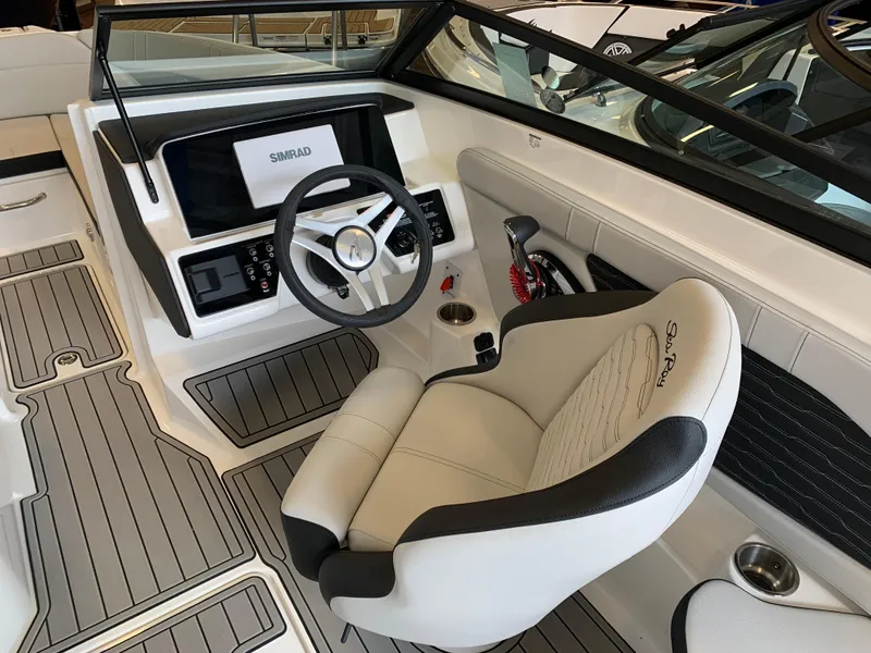 Slide: The Image of Interior of 2025 Sea Ray SPX 230 boat, featuring modern steering and seating. - 6