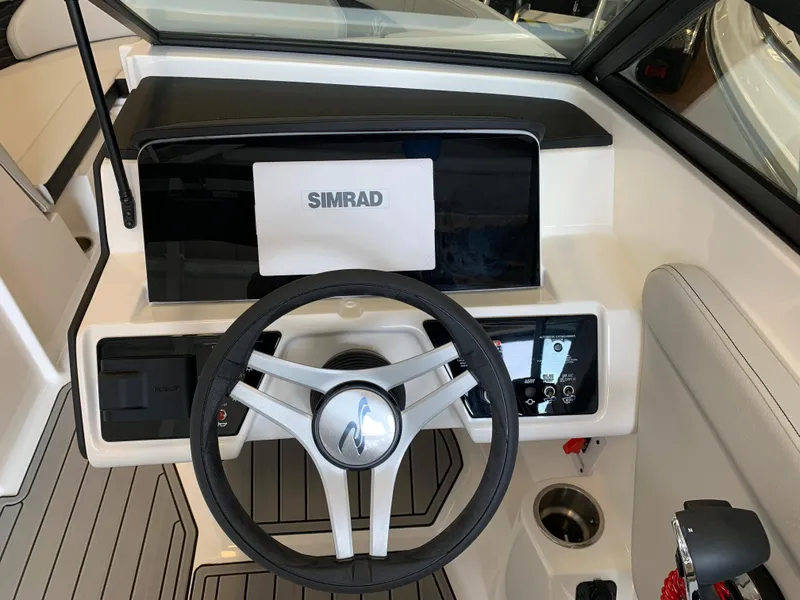 Slide: The Image of 2025 Sea Ray SPX 230 boat dashboard with Simrad display and steering wheel. - 7