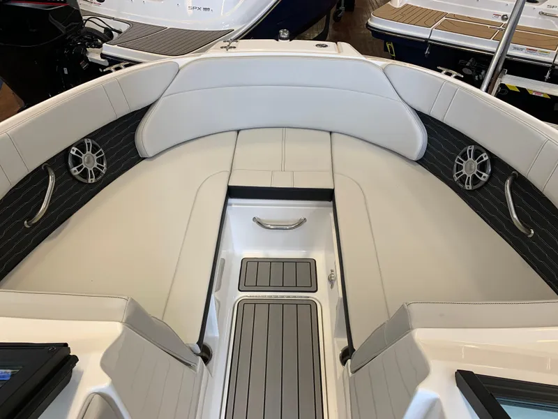 Slide: The Image of 2025 Sea Ray SPX 230 boat interior with white seating and sleek design. - 8