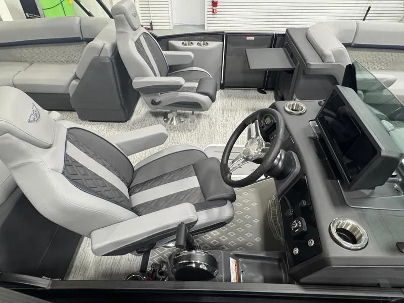 Slide: The Image of 2025 Bennington M Quad Bench 22 MFB interior with modern seating and control panel. - 13
