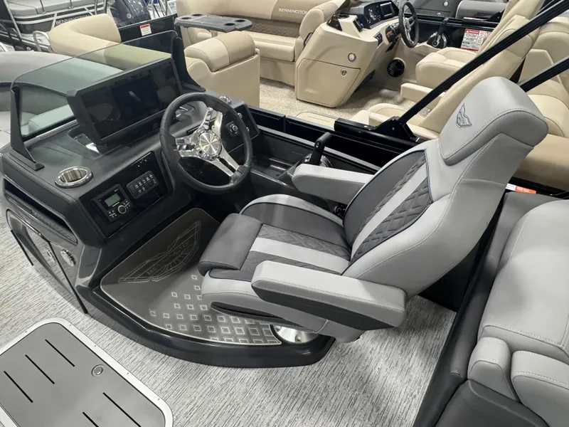 Slide: The Image of 2025 Bennington M Quad Bench 22 MFB boat interior with modern helm and seating. - 14