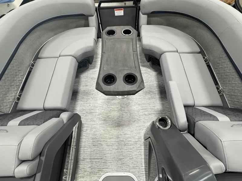 Slide: The Image of 2025 Bennington M Quad Bench 22 MFB interior with gray seating and cup holders. - 20