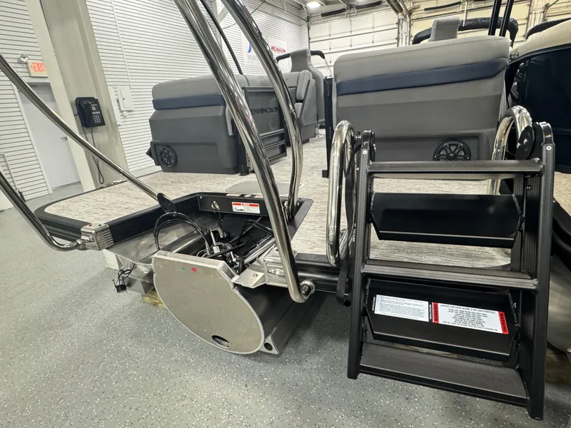 Slide: The Image of Bennington M Quad Bench 22 MFB 2025 boat interior with seating and ladder. - 21