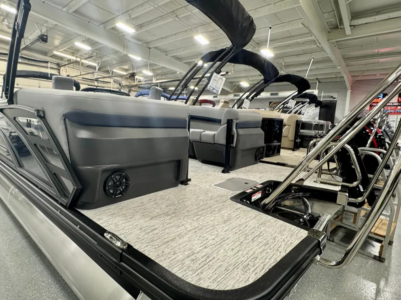Slide: The Image of 2025 Bennington M Quad Bench 22 MFB pontoon boat interior in showroom. - 22