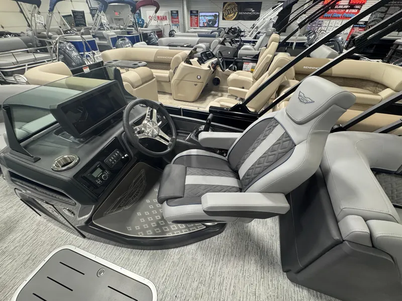 Slide: The Image of 2025 Bennington M Quad Bench 22 MFB boat interior with luxurious seating and modern dashboard. - 9