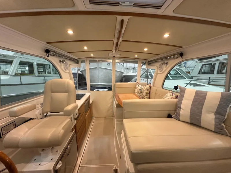 Slide: The Image of Interior of 2018 Back Cove 32 yacht with beige seating and helm station. - 12