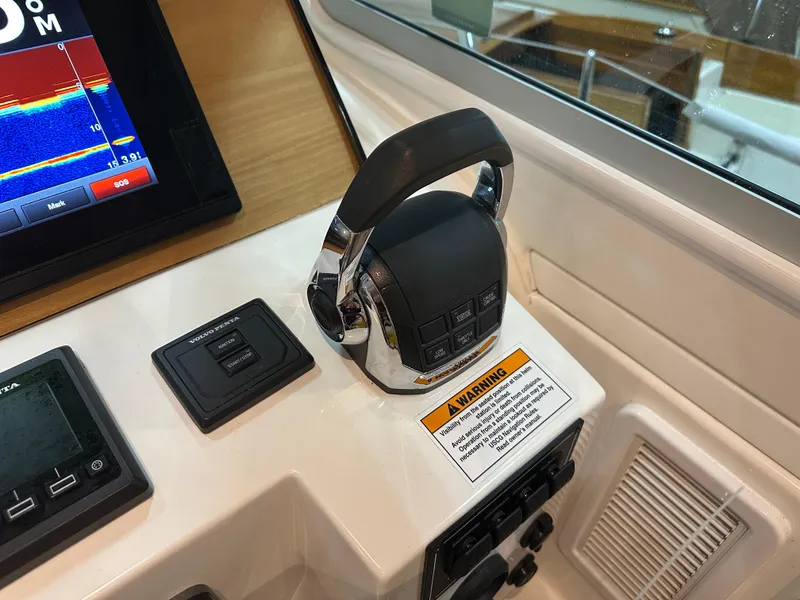 Slide: The Image of Control panel of a 2018 Back Cove 32 boat with throttle and display screen. - 21