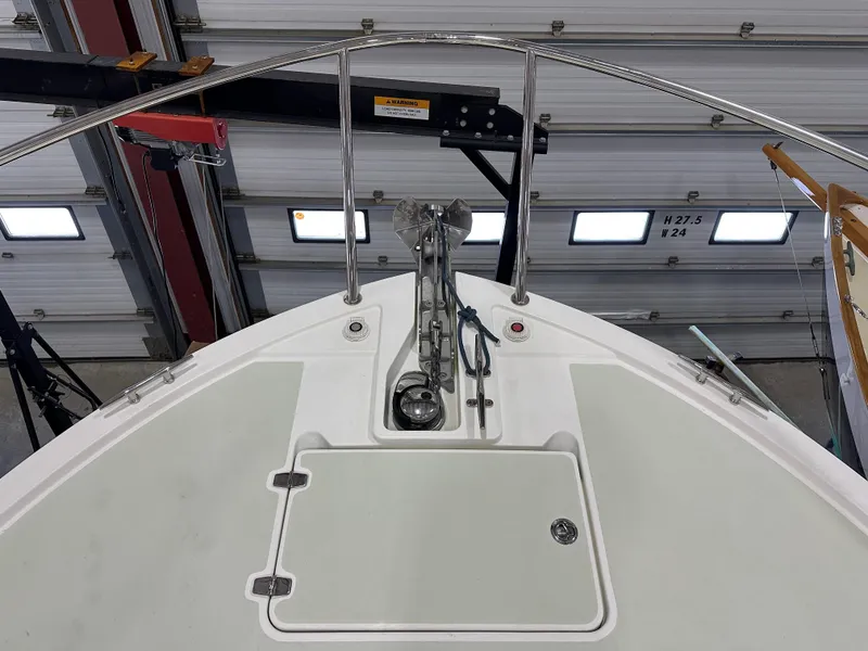 Slide: The Image of 2018 Back Cove 32 boat bow with anchor and railing in a garage setting. - 25