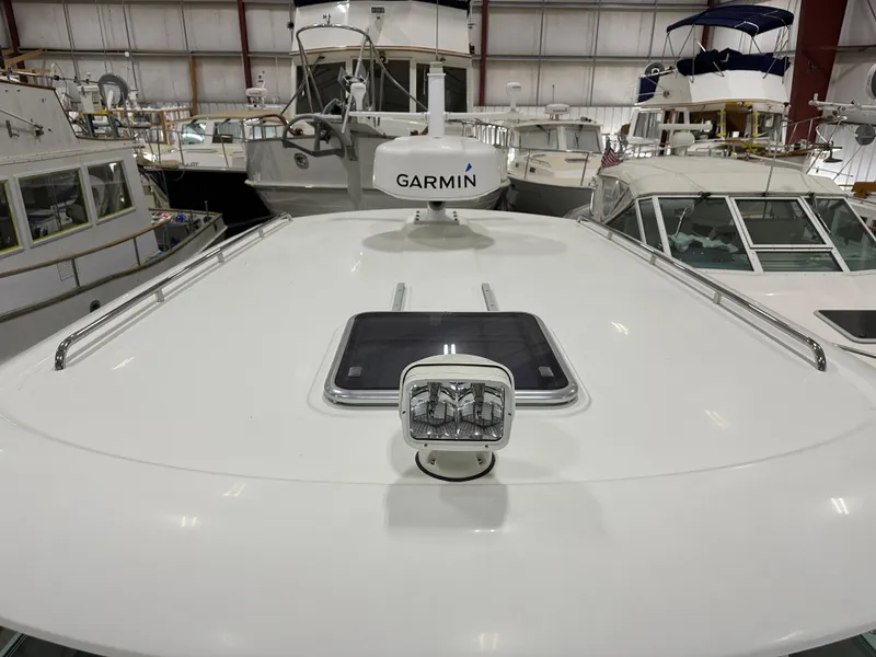 Slide: The Image of 2018 Back Cove 32 boat with Garmin radar, docked indoors among other vessels. - 27