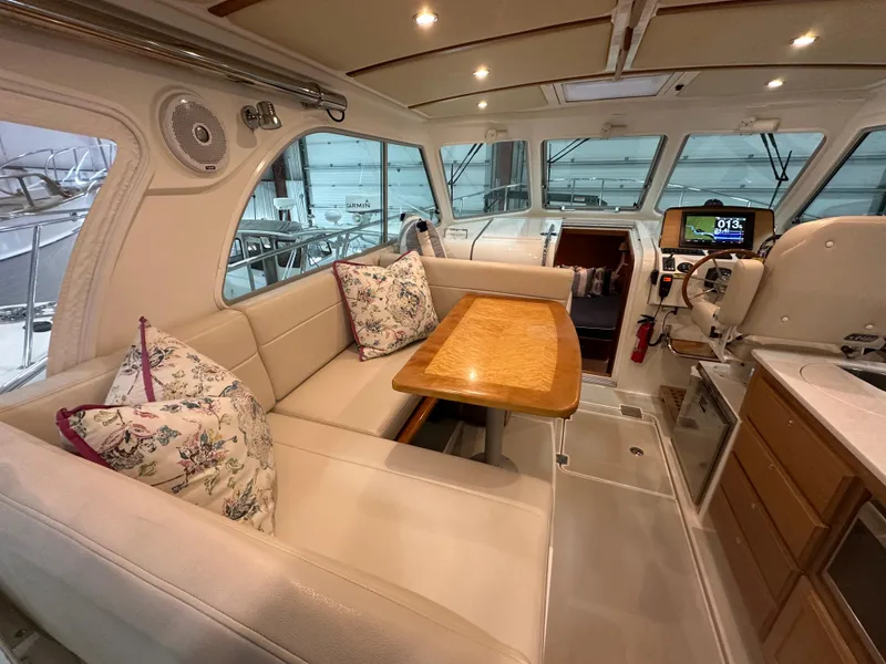 Slide: The Image of Interior of a 2018 Back Cove 32 boat with seating and helm station. - 3