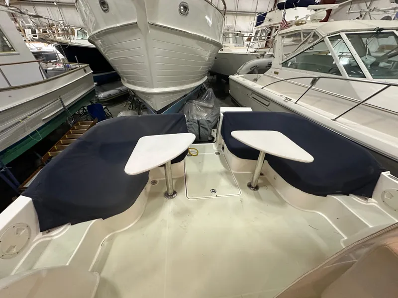 Slide: The Image of 2018 Back Cove 32 boat interior with seating and tables in a storage facility. - 30
