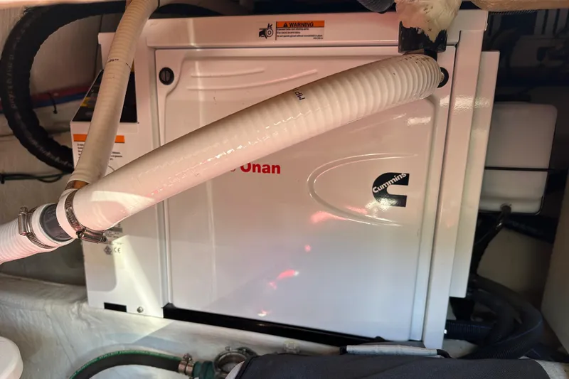 Slide: The Image of Engine compartment of a 2018 Back Cove 32 boat featuring a Cummins Onan generator. - 36